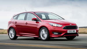 Sleek Ford Focus Cruising Through A City Landscape Wallpaper