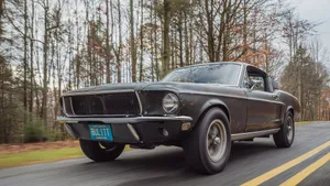 Sleek Ford Mustang Bullitt Roaring On The Open Road Wallpaper