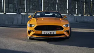 Sleek Ford Mustang Gt Convertible Gliding Down The Open Road Wallpaper