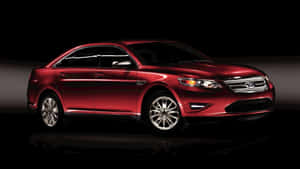 Sleek Ford Taurus Cruising Down The Highway Wallpaper