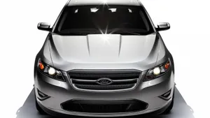 Sleek Ford Taurus Gliding On The Open Road Wallpaper