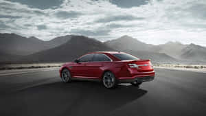 Sleek Ford Taurus In Motion On The Road Wallpaper