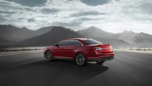 Sleek Ford Taurus In Motion On The Road Wallpaper