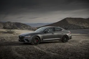 Sleek Genesis G70 Driving Into The Sunset Wallpaper