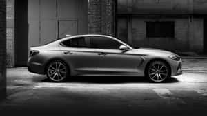 Sleek Genesis G70 Sports Sedan Cruising The City Streets Wallpaper