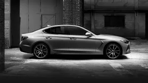 Sleek Genesis G70 Sports Sedan Cruising The City Streets Wallpaper