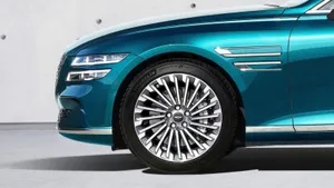 Sleek Genesis Gv60 Electric Vehicle In Motion Wallpaper