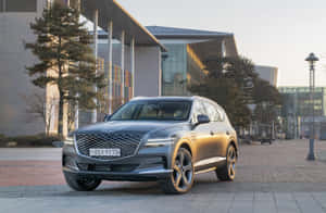 Sleek Genesis Gv80 Suv Cruising On A Highway Wallpaper