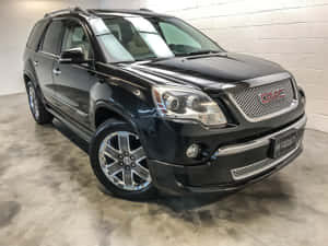 Sleek Gmc Acadia Cruising In The City Wallpaper