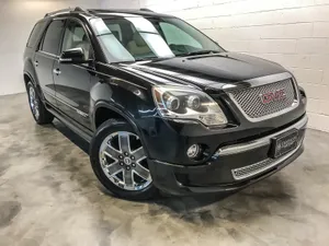 Sleek Gmc Acadia Cruising In The City Wallpaper