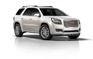 Sleek Gmc Acadia Cruising On A Scenic Road Wallpaper