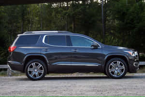 Sleek Gmc Acadia Cruising On An Open Road Wallpaper