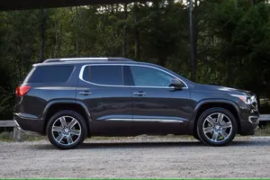 Sleek Gmc Acadia Cruising On An Open Road Wallpaper