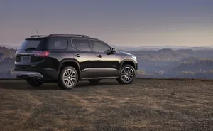 Sleek Gmc Acadia On A Scenic Road Trip Wallpaper