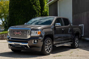 Sleek Gmc Canyon Driving Off-road On A Rugged Terrain Wallpaper