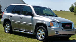 Sleek Gmc Envoy In Natural Setting Wallpaper