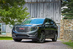 Sleek Gmc Terrain Suv Cruising On A Picturesque Road Wallpaper