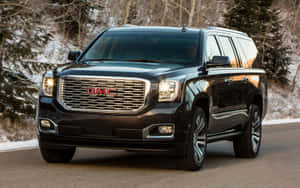 Sleek Gmc Yukon Cruising On The Open Road Wallpaper