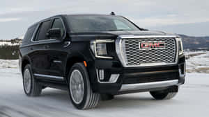 Sleek Gmc Yukon On The Road Wallpaper