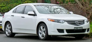 Sleek Honda Accord With Headlights On Wallpaper