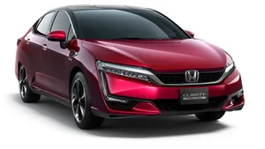 Sleek Honda Clarity In Motion On A Picturesque Highway Wallpaper