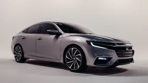 Sleek Honda Insight Cruising On The Open Road Wallpaper