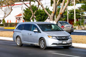 Sleek Honda Odyssey Minivan In Motion Wallpaper