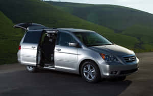 Sleek Honda Odyssey On The Road Wallpaper