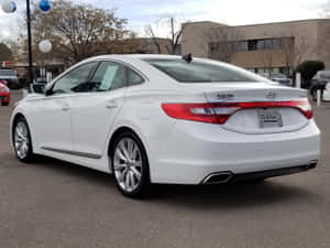 Sleek Hyundai Azera Cruising On A Scenic Road Wallpaper