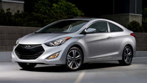 Sleek Hyundai Elantra Driving Through The City Wallpaper