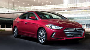 Sleek Hyundai Elantra In Vibrant City Setting Wallpaper