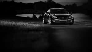 Sleek Hyundai Genesis Cruising At Sunset Wallpaper