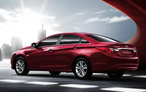 Sleek Hyundai Sonata Driving On An Open Road. Wallpaper