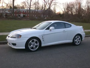 Sleek Hyundai Tiburon In A Stunning Landscape Wallpaper