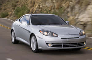 Sleek Hyundai Tiburon In The Wild Wallpaper