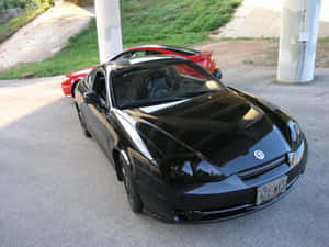 Sleek Hyundai Tiburon On The Road Wallpaper