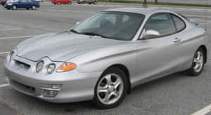 Sleek Hyundai Tiburon Sports Car On An Open Road Wallpaper