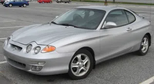 Sleek Hyundai Tiburon Sports Car On An Open Road Wallpaper