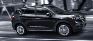 Sleek Hyundai Tucson On The Road Wallpaper