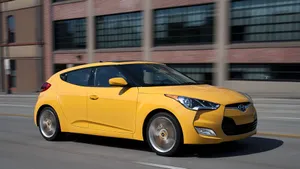 Sleek Hyundai Veloster Cruising The City Streets Wallpaper