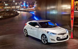 Sleek Hyundai Veloster In A Cityscape At Dusk Wallpaper