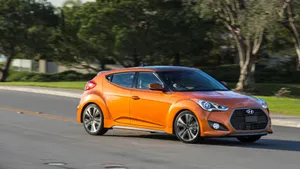 Sleek Hyundai Veloster In A Scenic Cityscape Wallpaper