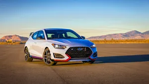Sleek Hyundai Veloster On Urban Street Wallpaper