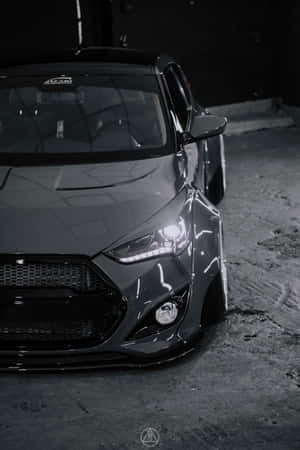 Sleek Hyundai Veloster Parked On A Scenic Road Wallpaper