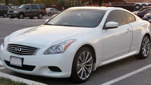 Sleek Infiniti G37 Cruising On A High Road Wallpaper