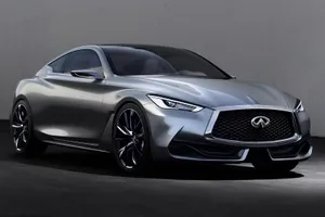 Sleek Infiniti Q60 Cruising Down A Winding Road Wallpaper