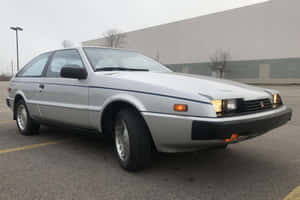 Sleek Isuzu Impulse Standing Out On A City Street Wallpaper