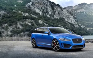 Sleek Jaguar Xfr Speeding On Open Road Wallpaper