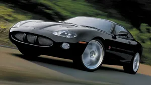 Sleek Jaguar Xkr Roaring On The Road Wallpaper