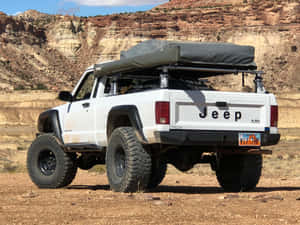 Sleek Jeep Comanche Conquering Rugged Terrain Wallpaper